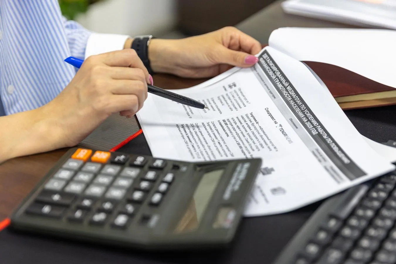 close-up of someone reviewing financial documents and calculations, the kind of compliance oversight a strong finance team needs