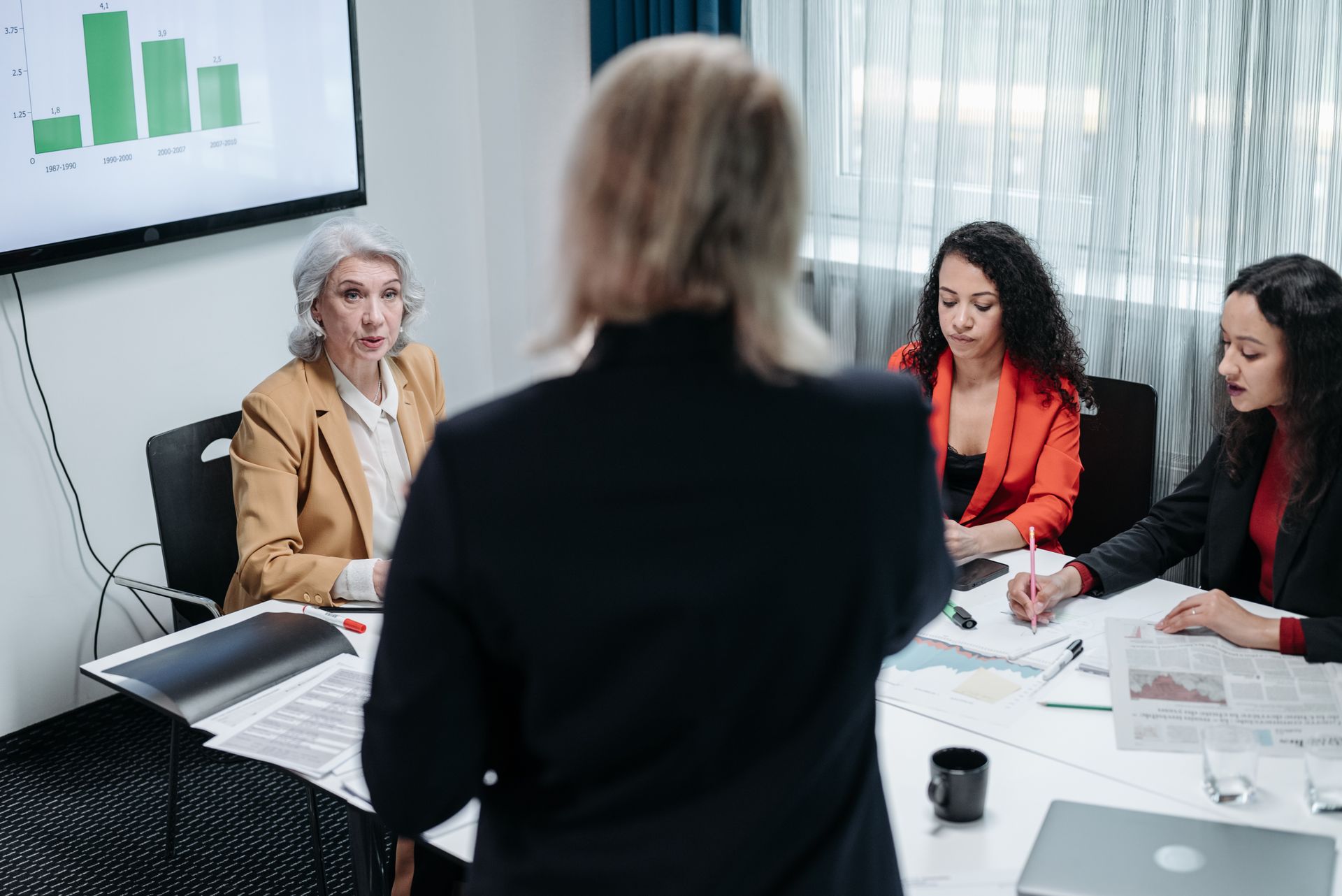 Two social care sector managers reviewing appointment and compliance documents together in an office meeting