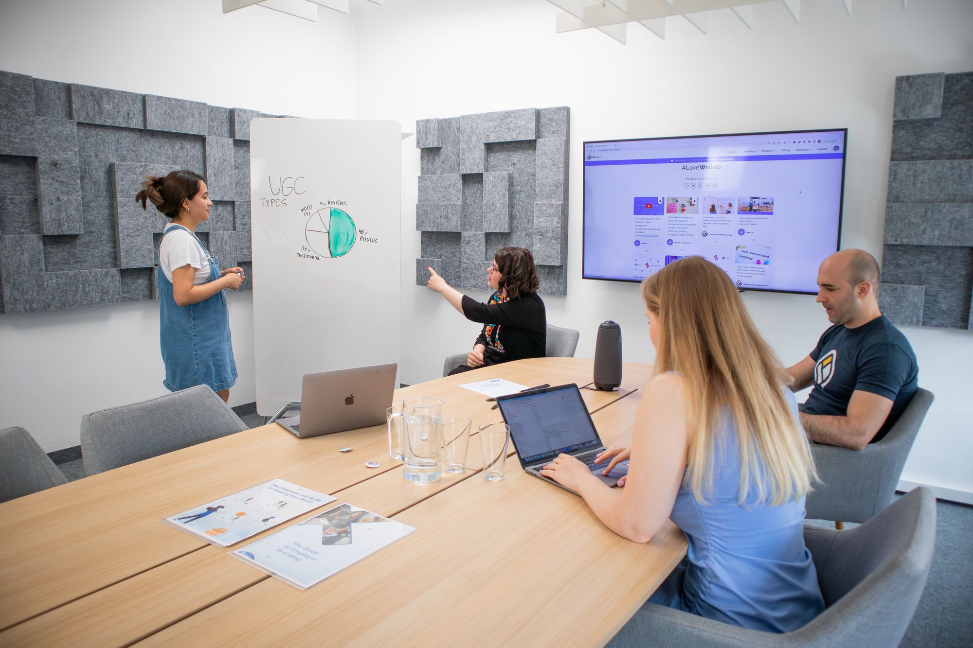 Marketing team reviewing a presentation together in an office, representing in-house marketing leadership
