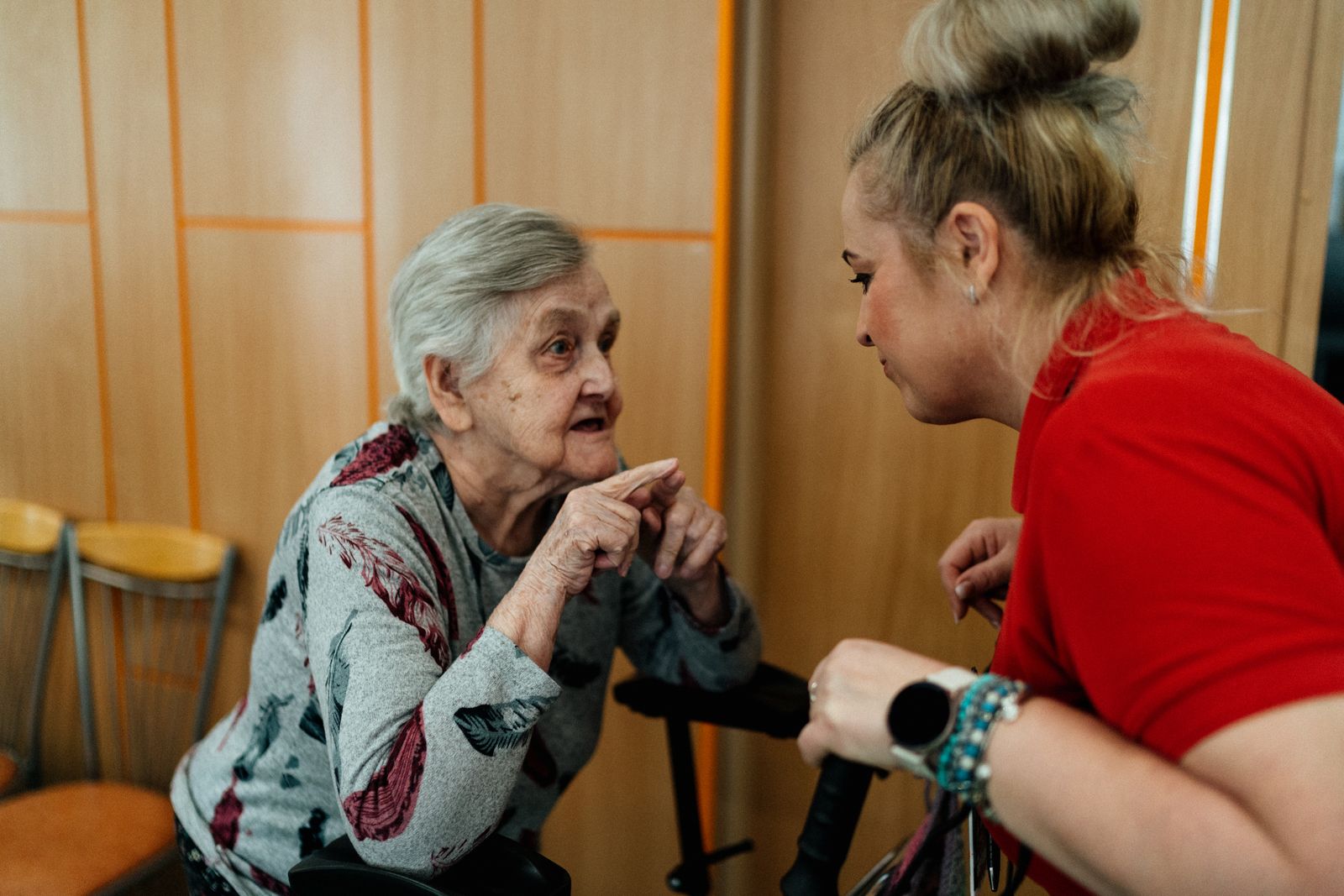 Elderly woman and care worker talking at home, as providers plan for a national pension scheme for care workers