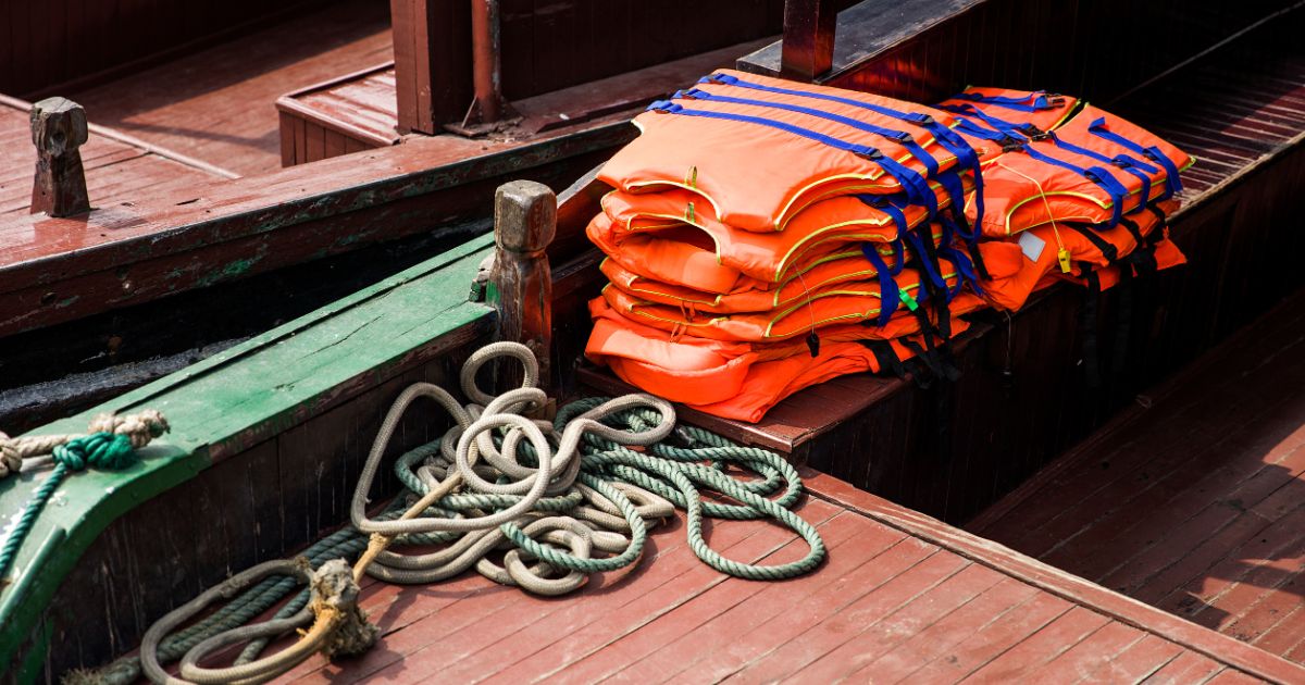 lifejackets lay on a dock 