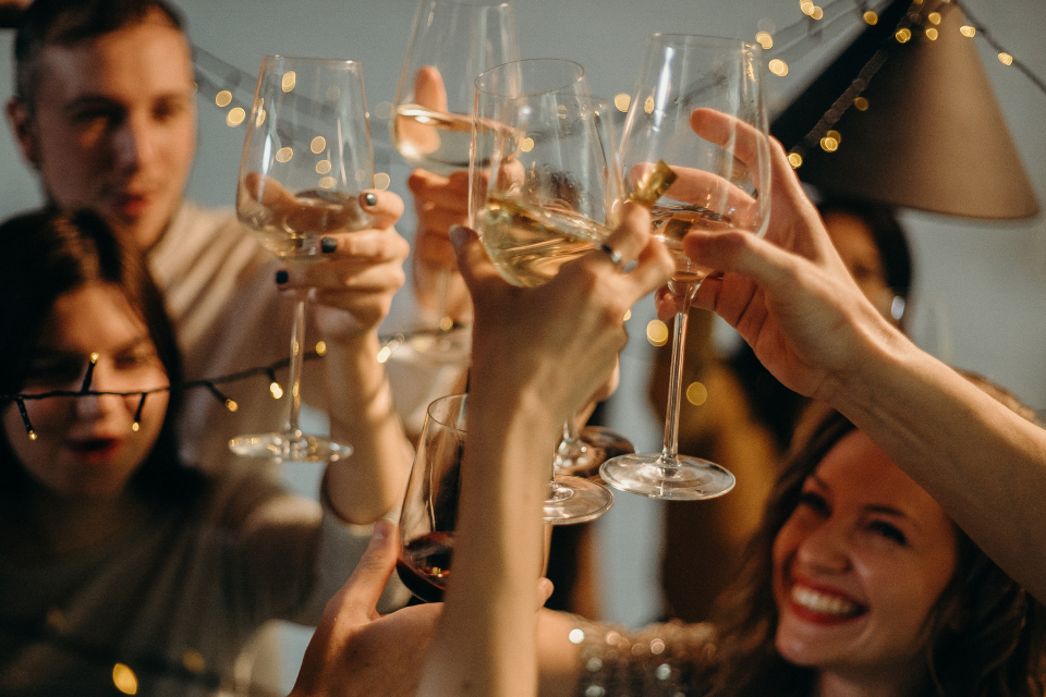 A group of friends raising a toast with champagne glasses.