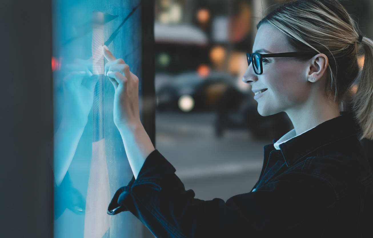 a woman using a smartboard while smiling