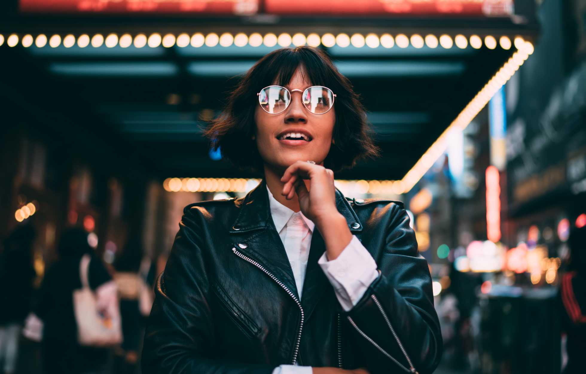a woman bathed in light smiling upwards