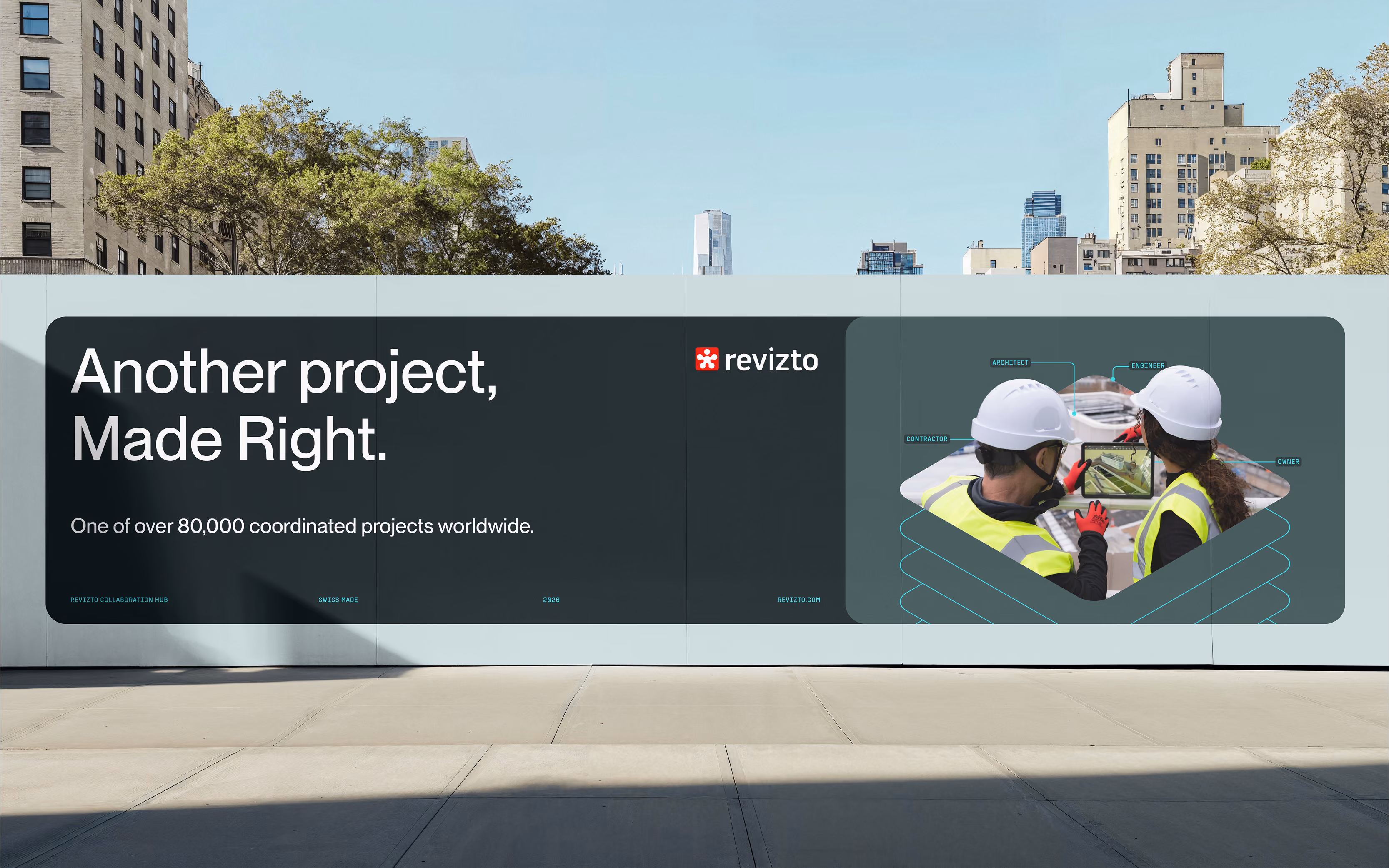 Revizto ad on wall with text 'Another project, Made Right' and two people in safety gear viewing a tablet.