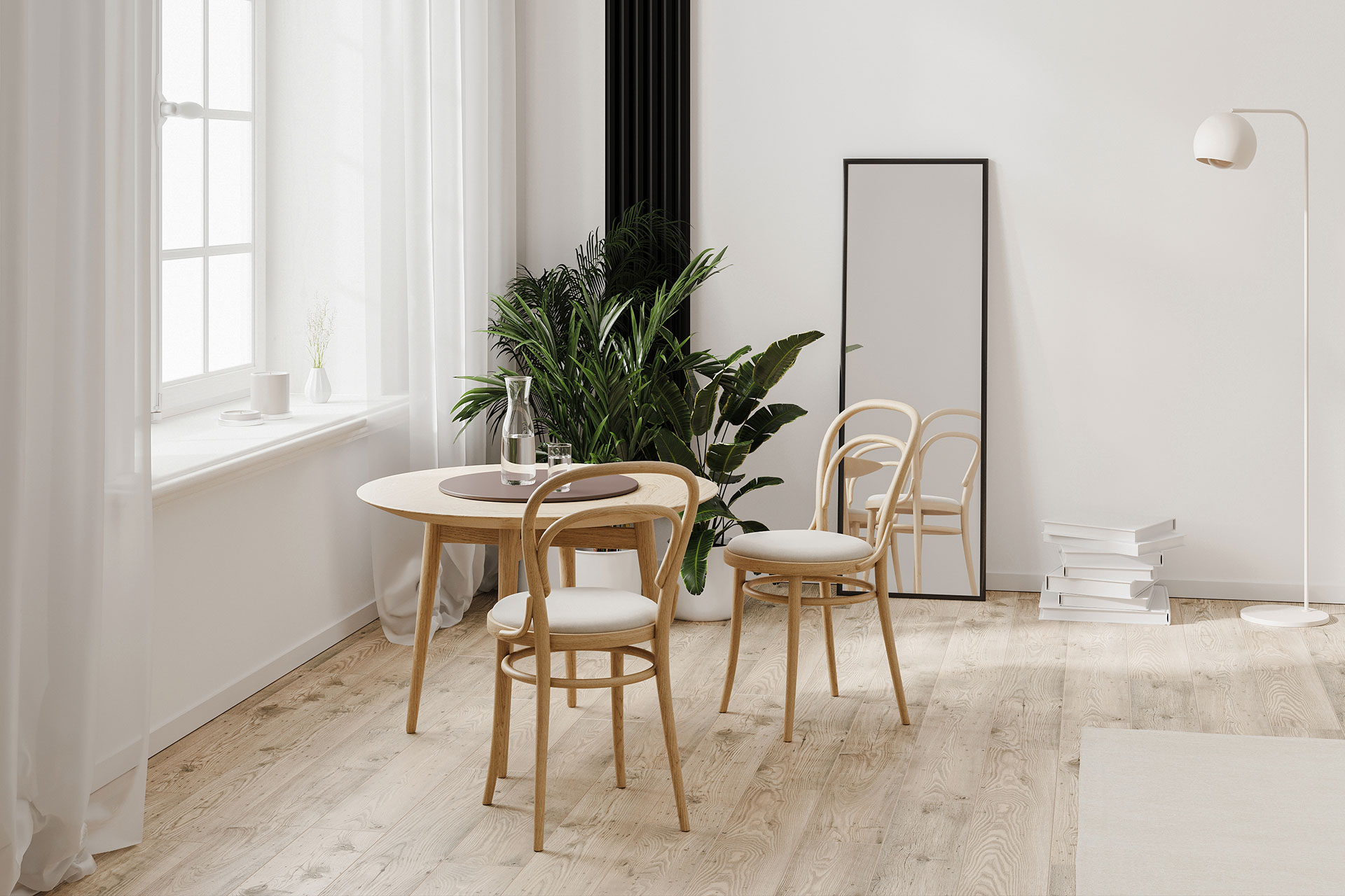 A small dining area with a round table sits atop hybrid flooring that combines laminate and a rug. The layered textures add warmth and define the cozy eating space.