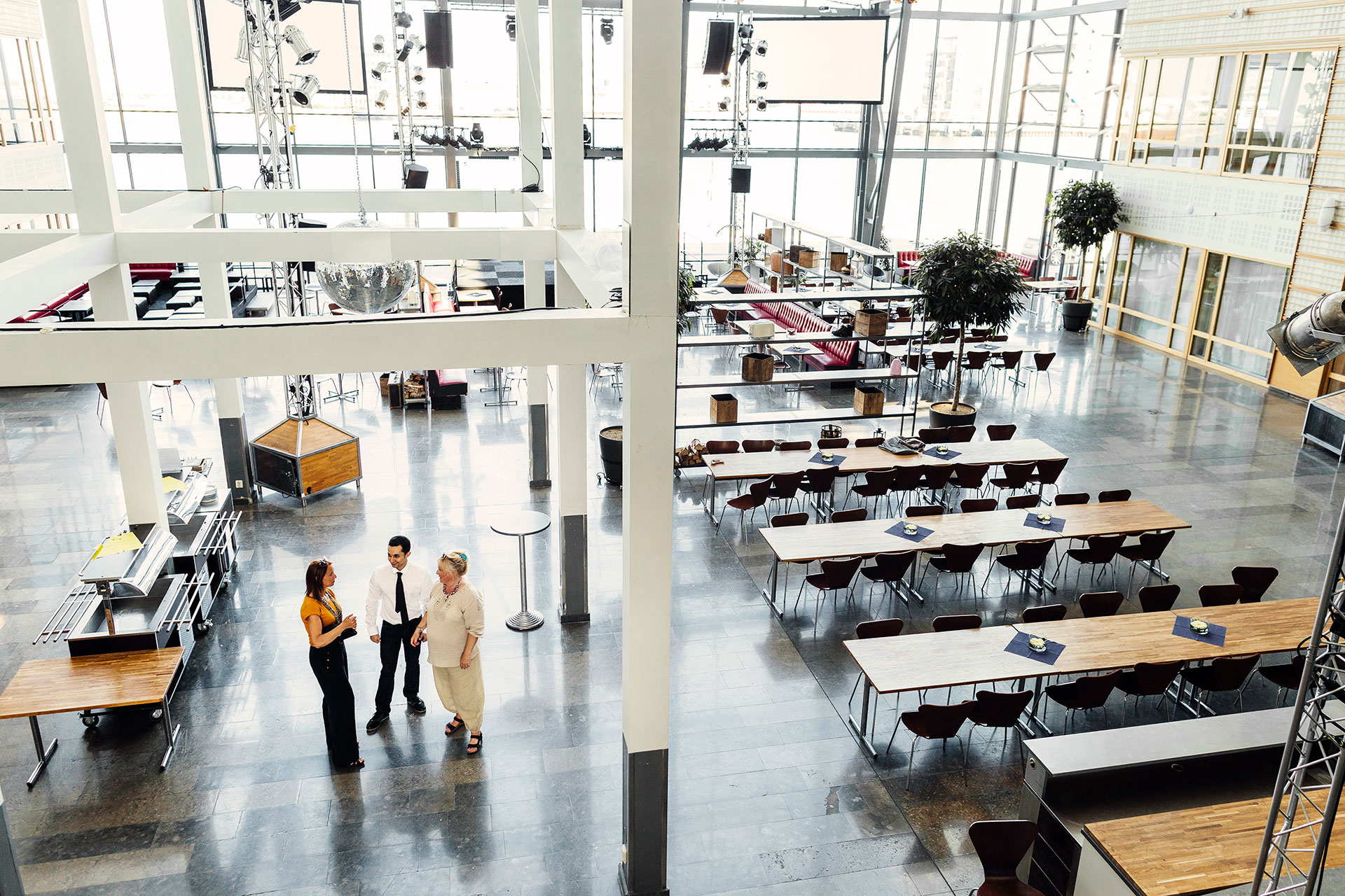 Overhead perspective of coworkers in conversation, highlighting contemporary flooring in the dining space.