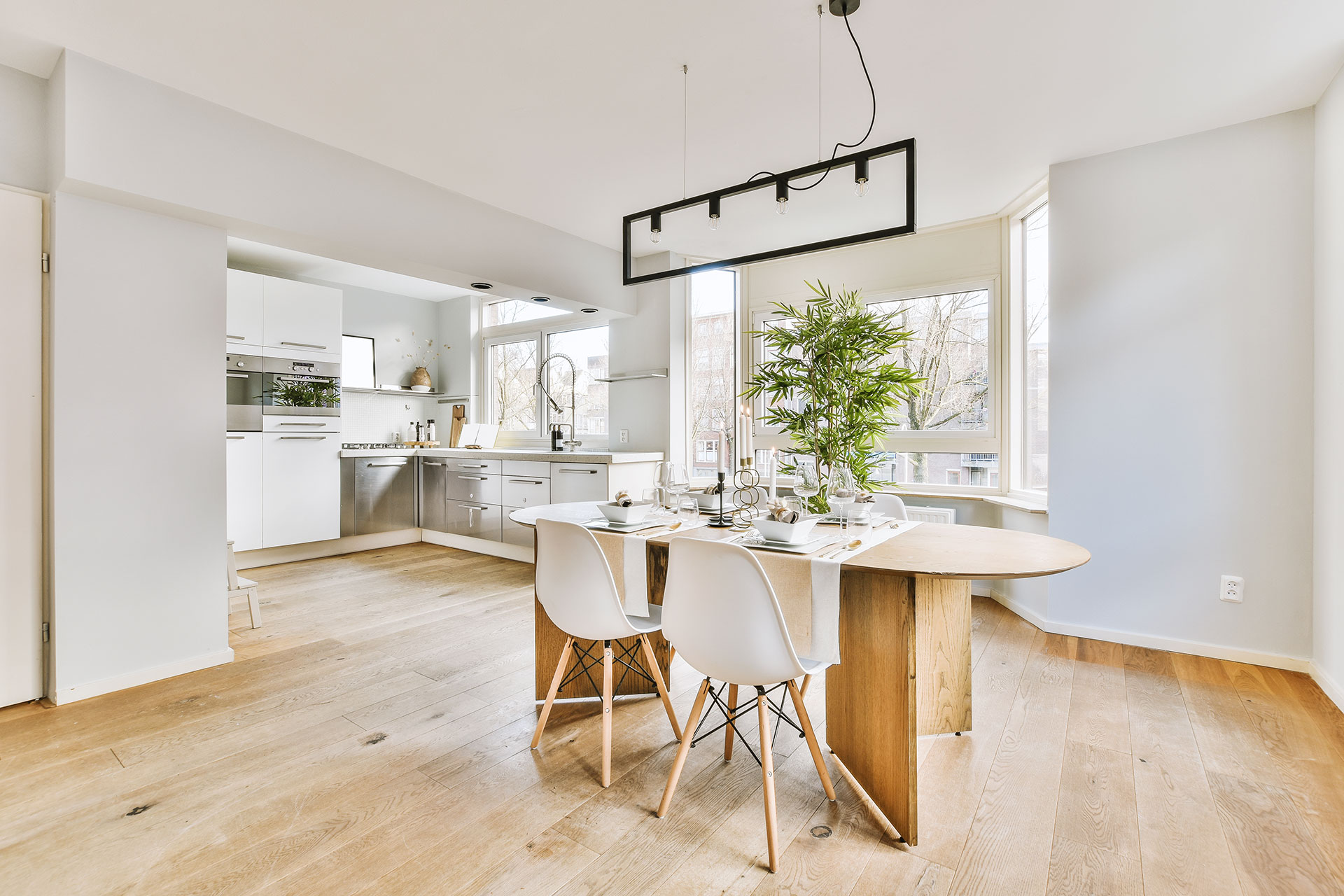 Hardwood timber grounds this luminous kitchen and dining area with a sophisticated and timeless look.