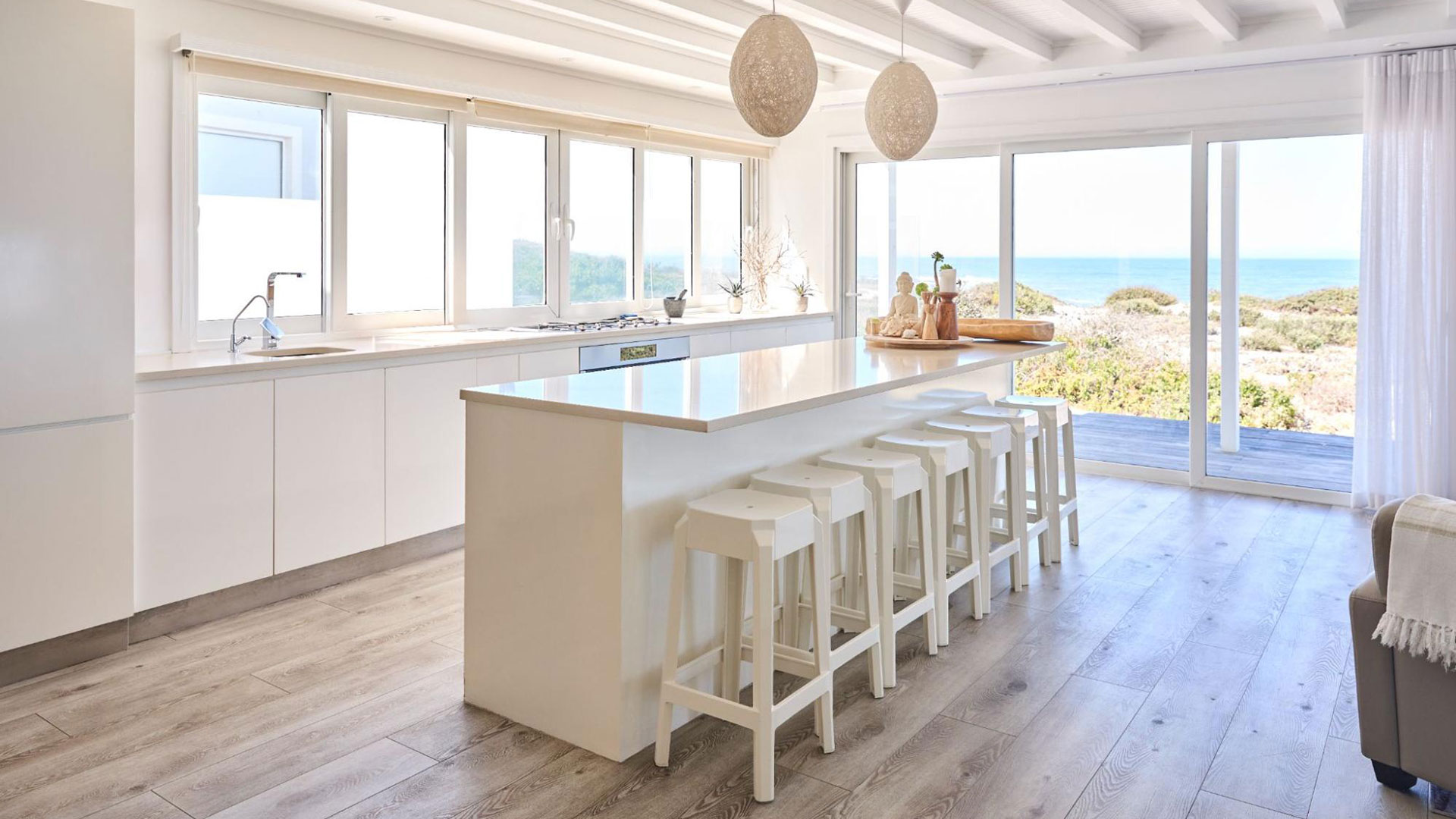 Vinyl planks add a durable and low-maintenance surface to this modern open kitchen space.