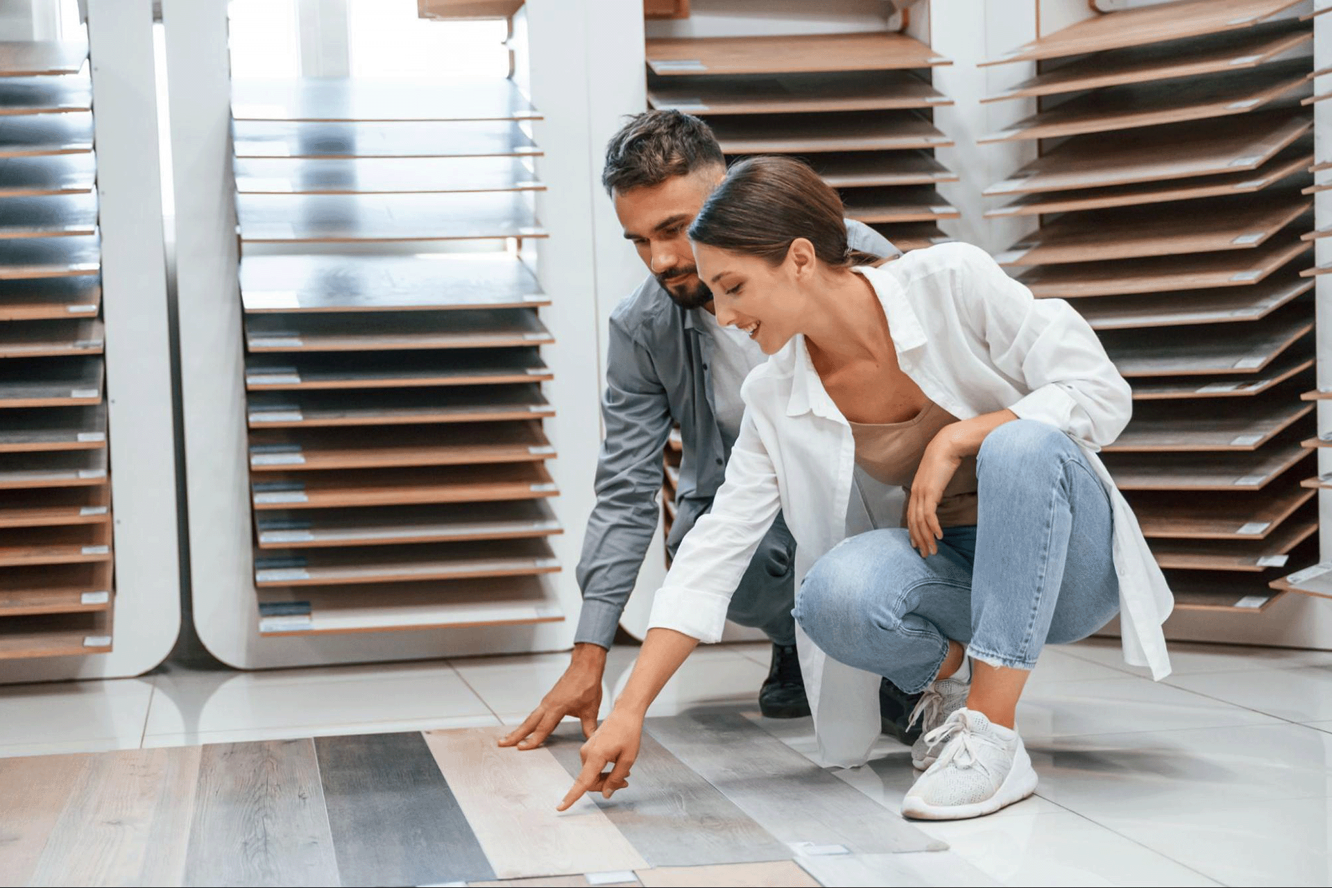 Young couple browsing flooring samples together in a showroom.