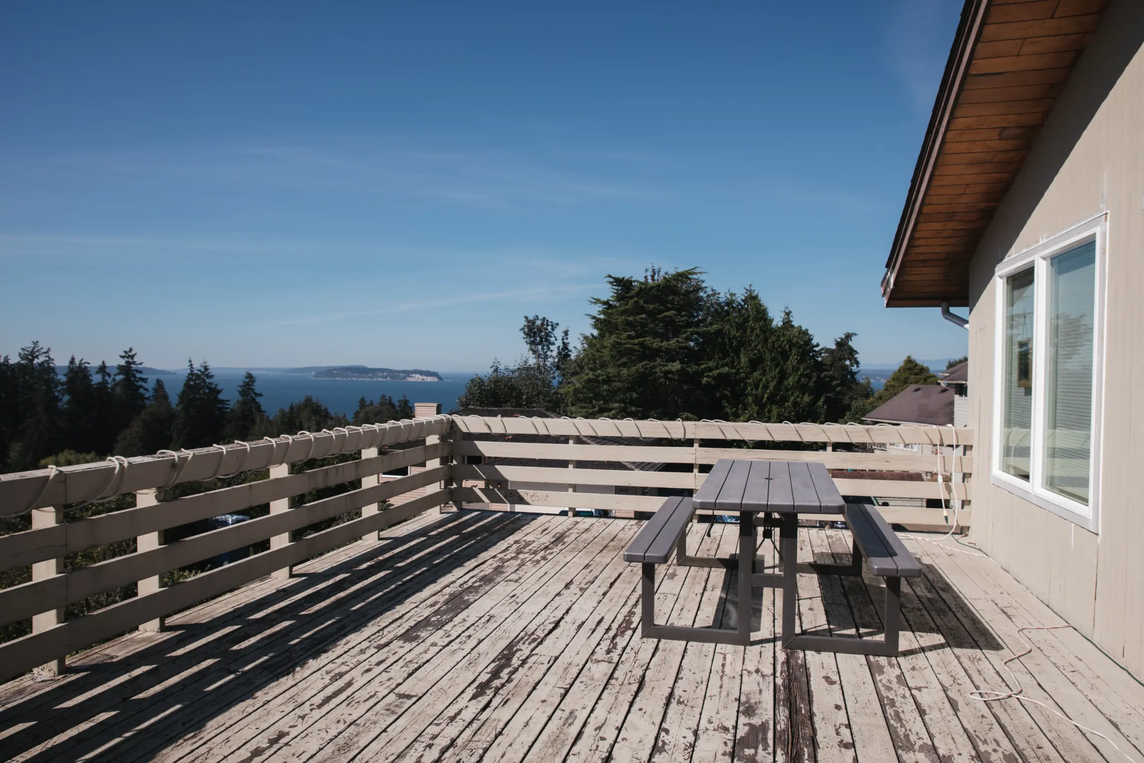 Original deck rail with outdated design and maintenance issues.