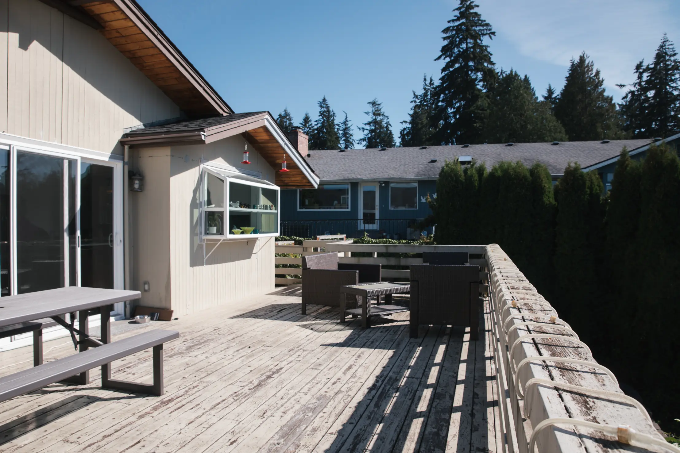 Aging second-story deck in need of structural and surface replacement.