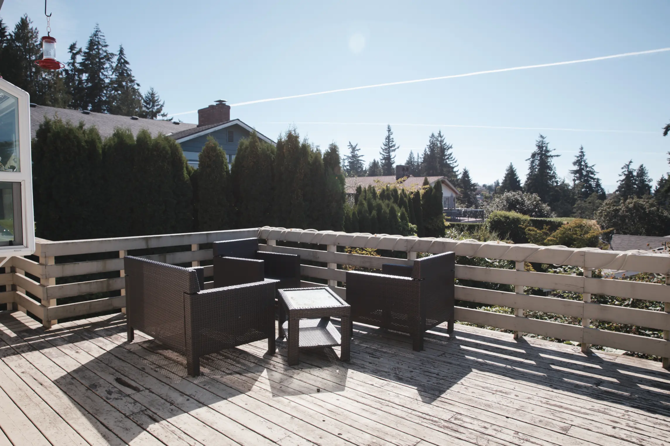 Worn-out deck structure with outdated railing and faded boards.