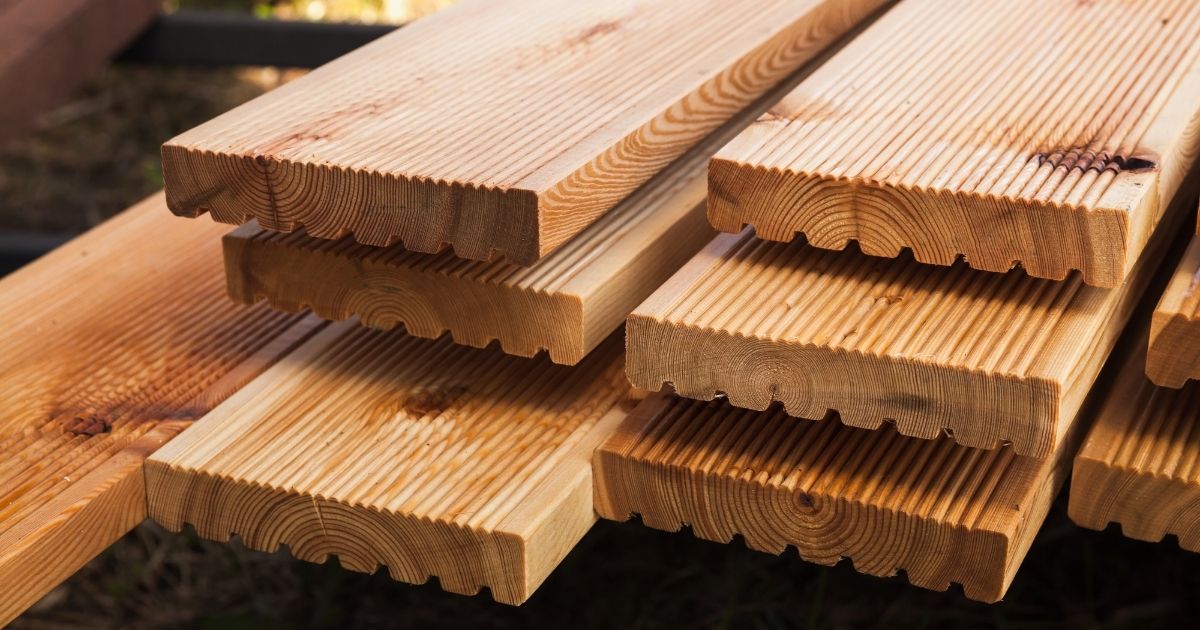 Stacked larch deck boards, close up outdoor photo