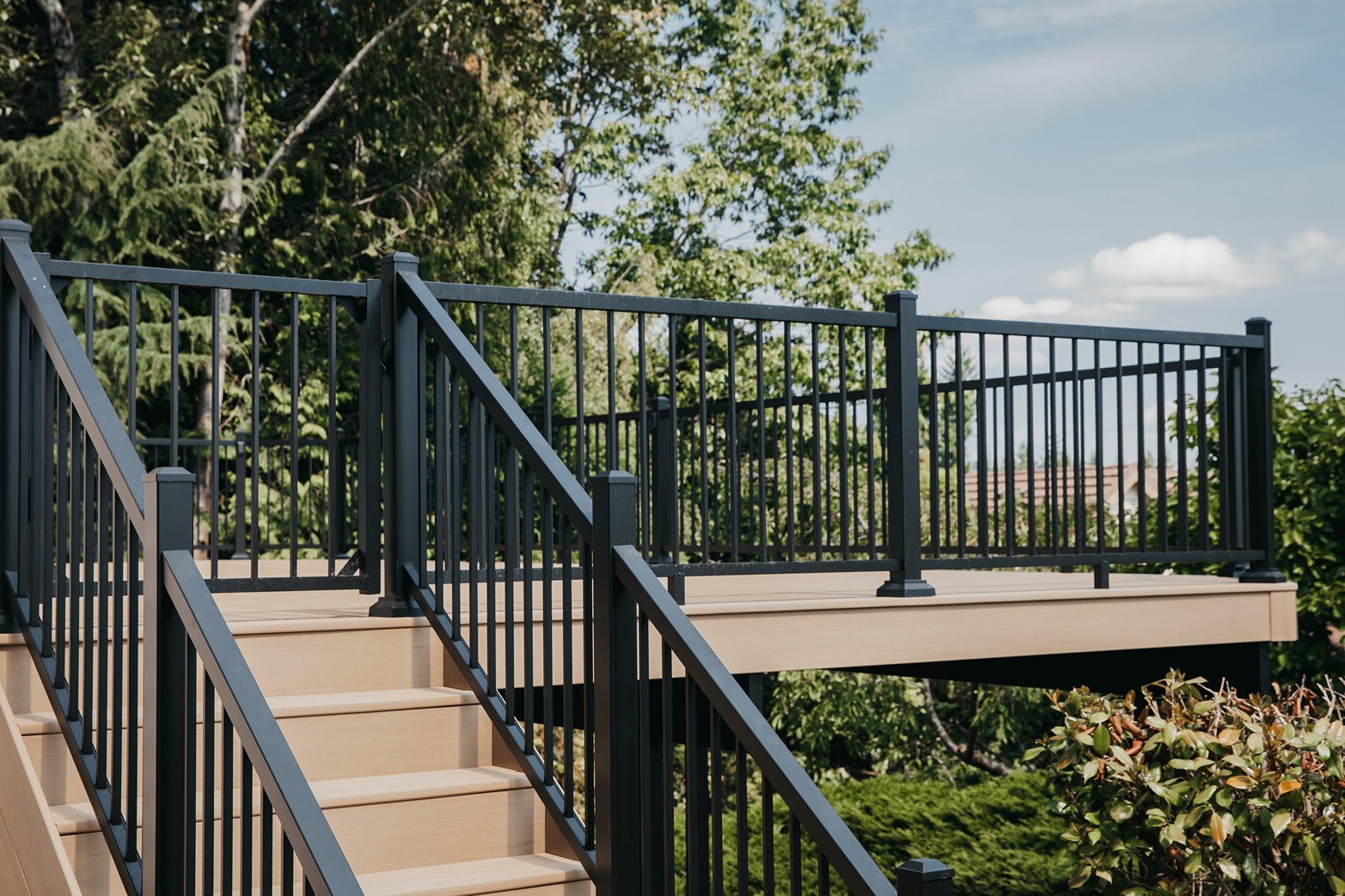 Black aluminum picket deck railing with square posts and flat top rail