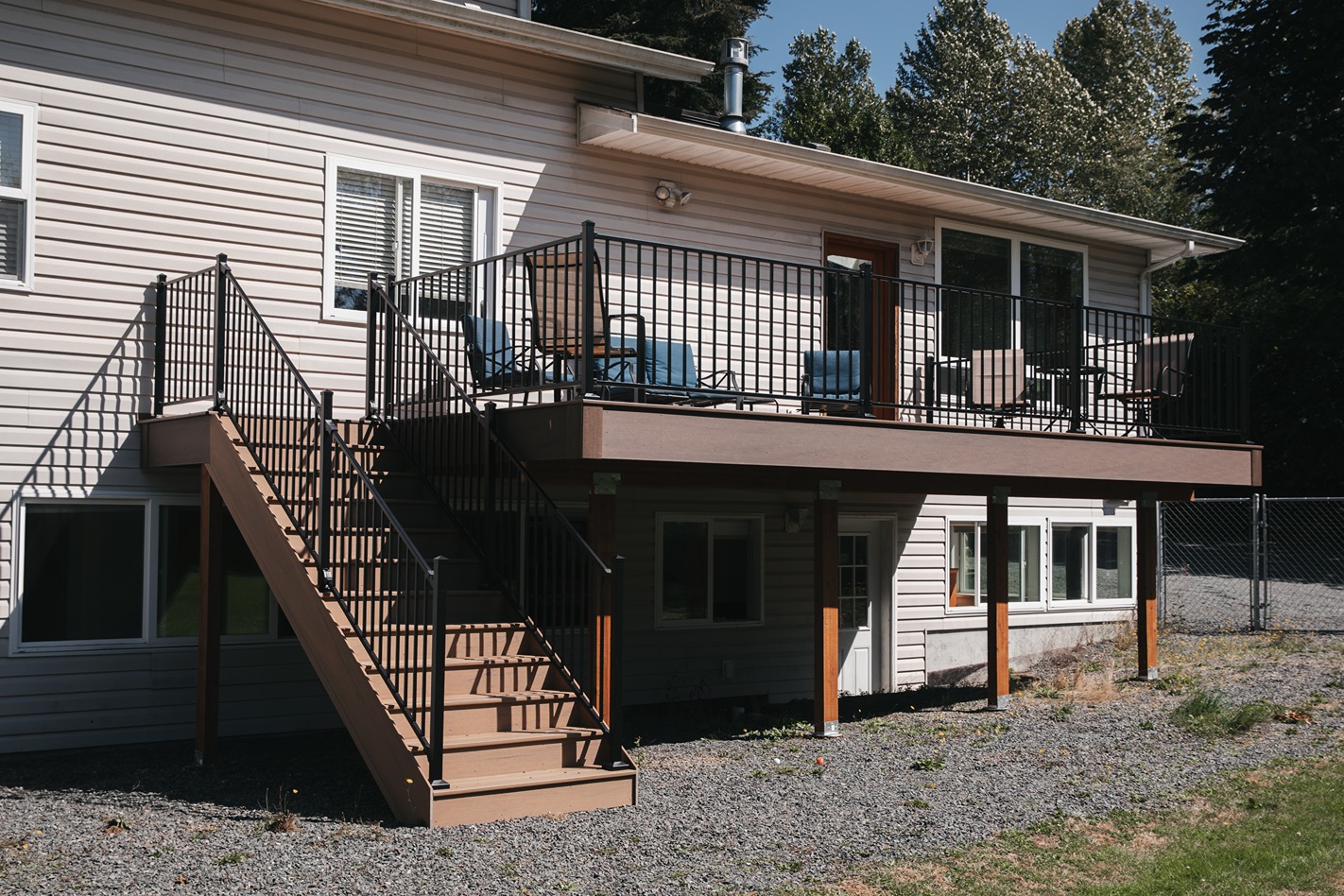 Two-story deck with black aluminum railing and exterior staircase
