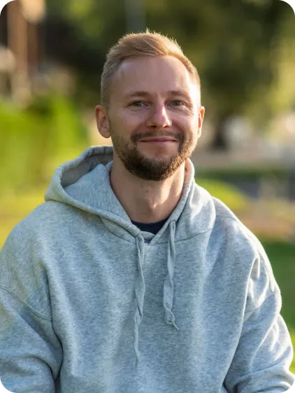 Man in blue hoodie smiling