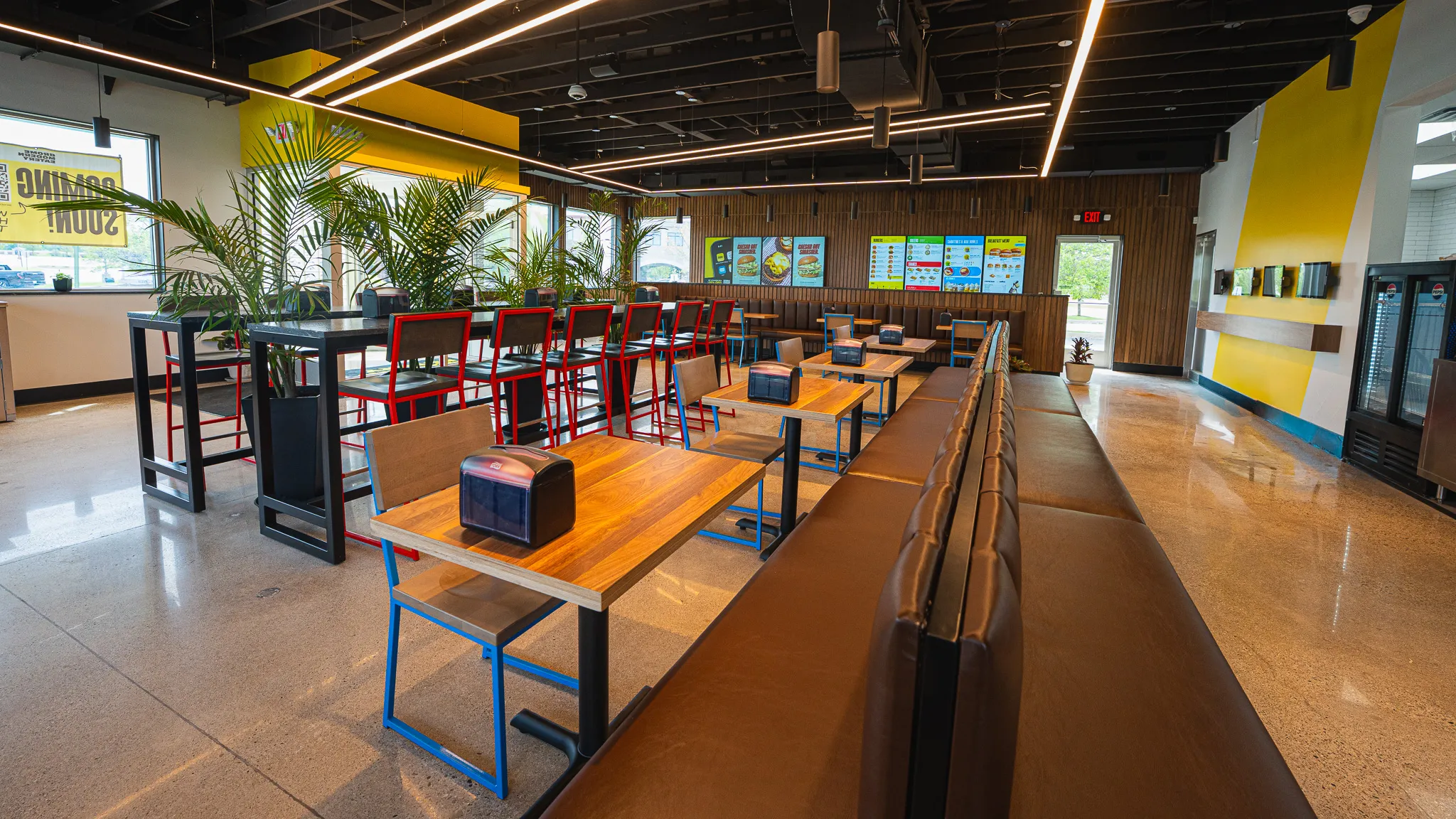 Inside Brome Modern Eatery: dining room with tables, booth seating and menu boards