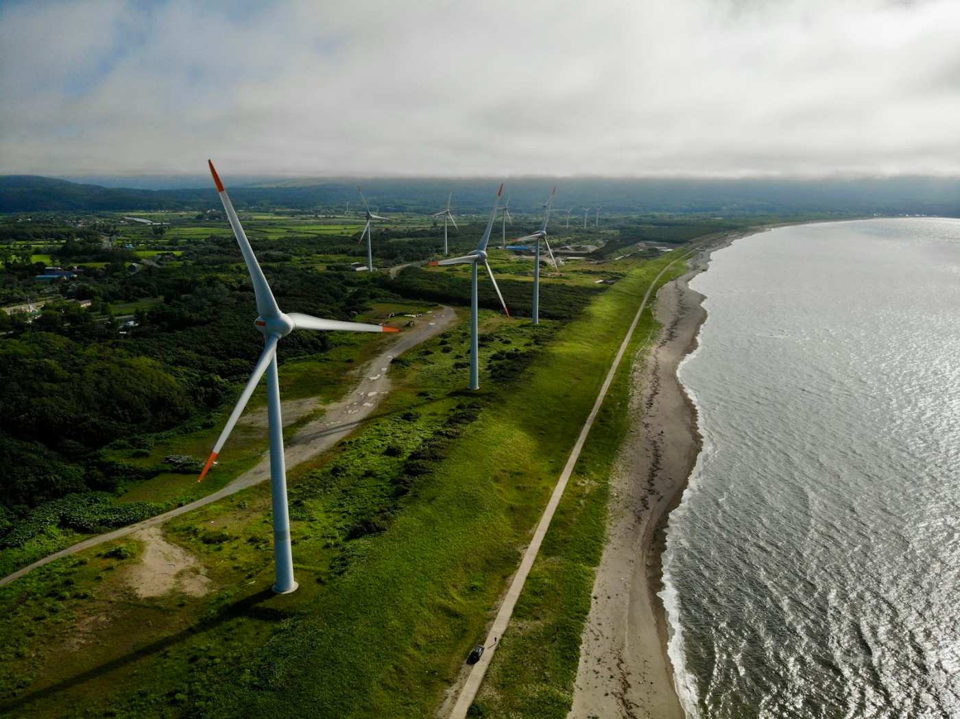 Aerial view of wind turbines along a coastline