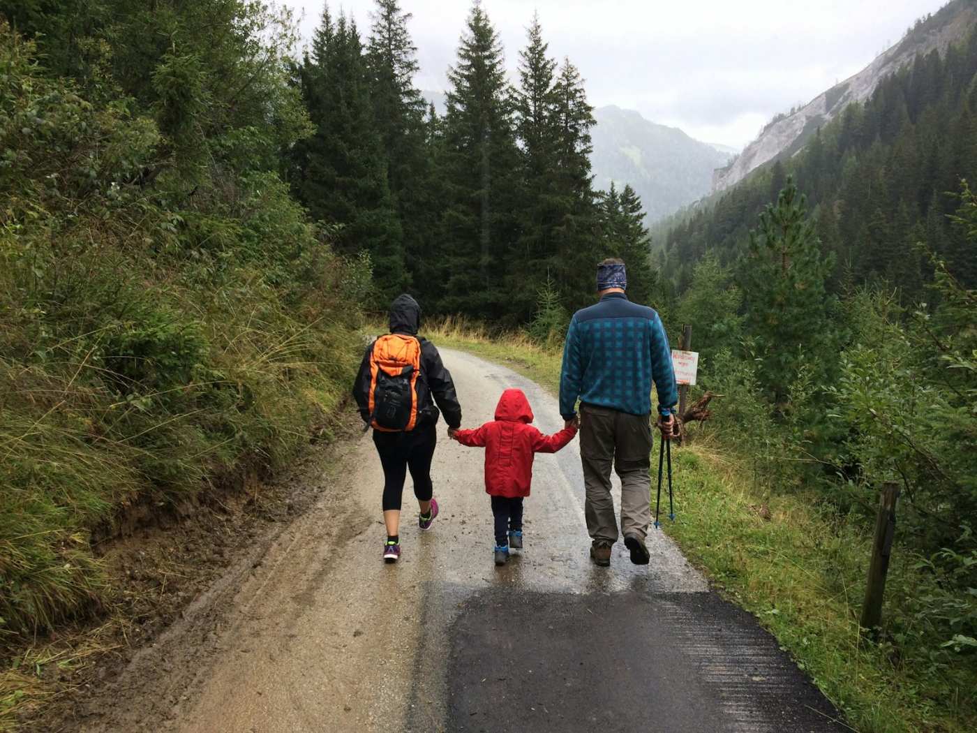 Three generations walking together on a forest path