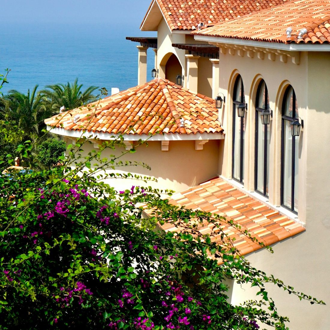 A villa with terracotta roofs overlooking the sea