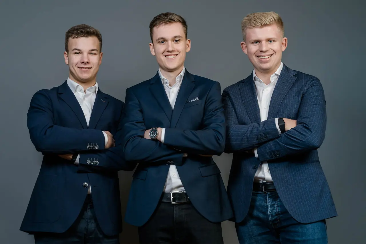 Image of a three humans posing with folded arms