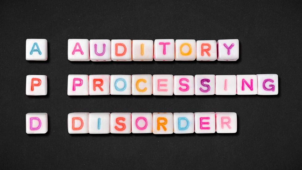 Colorful letter tiles spelling out Auditory Processing Disorder.