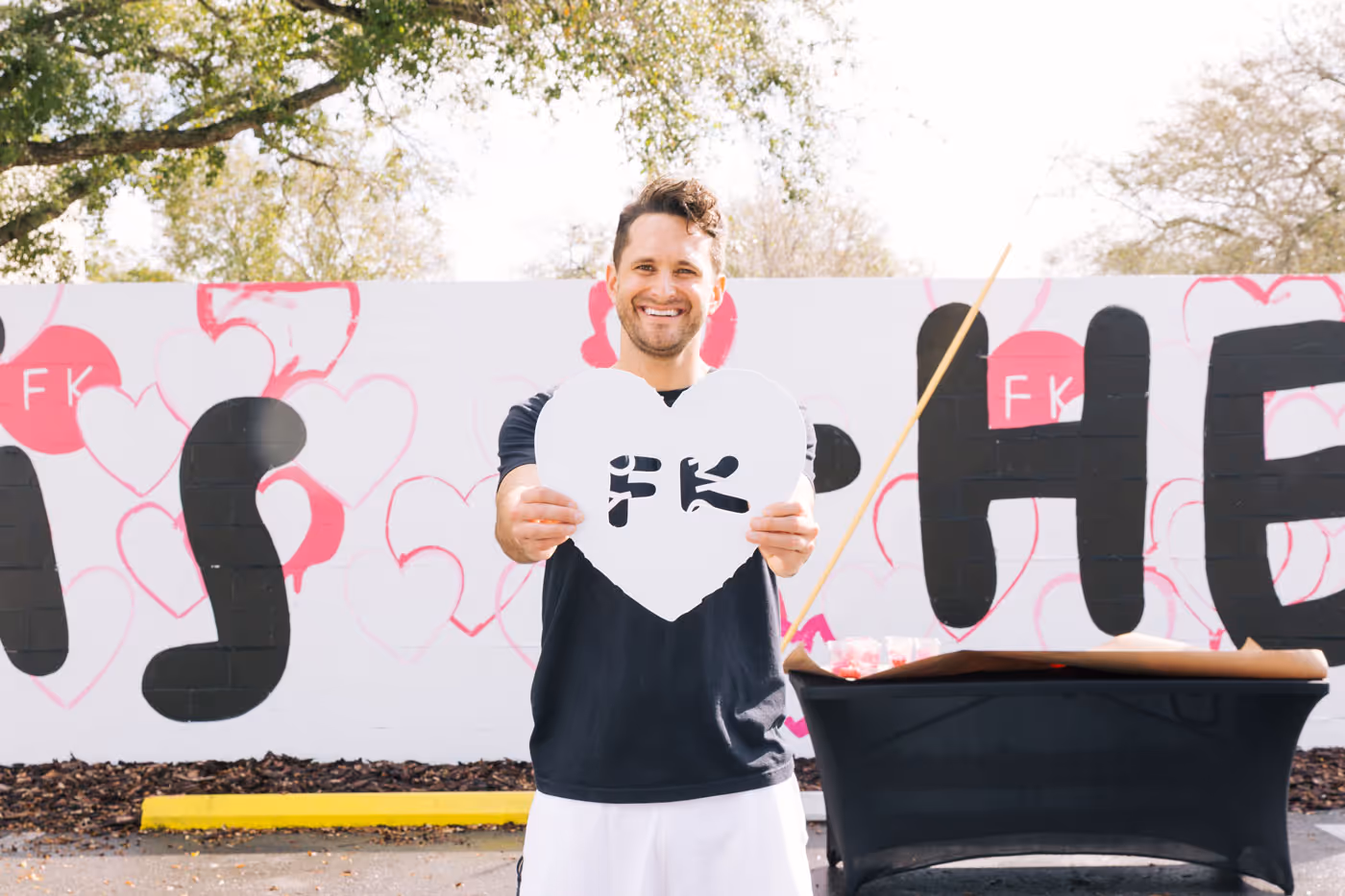 Fresh Kitchen owner holding heart sign