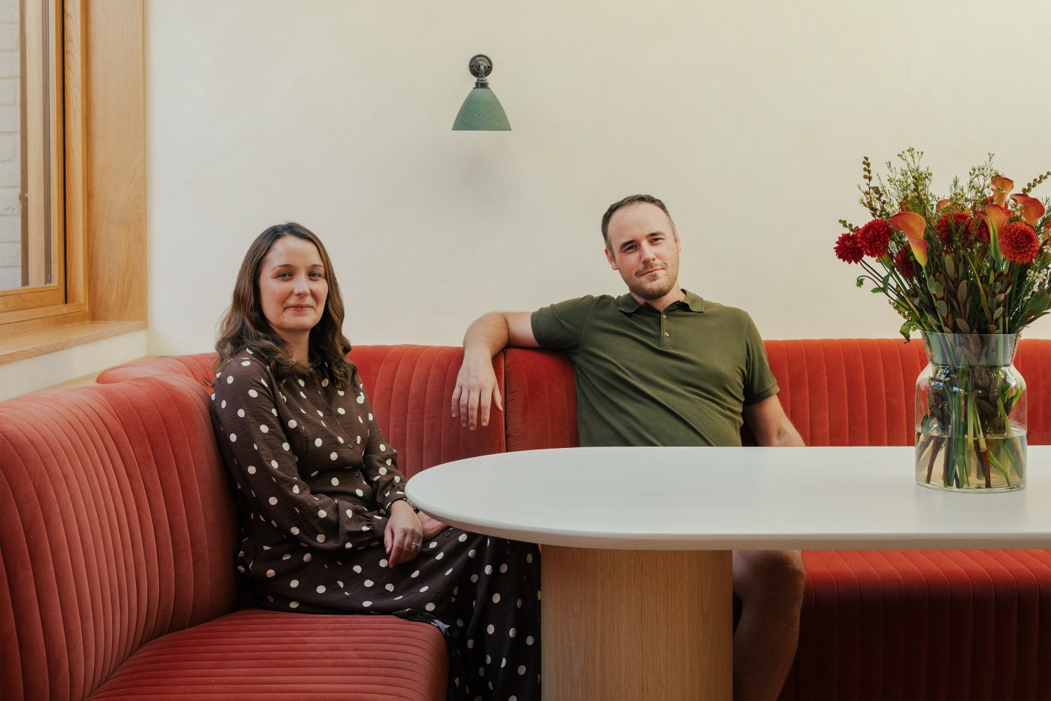 Ben and Joanna Wilkes of Benjamin Wilkes Architecture and Interior Design Studio sitting at a table in their Symposion House project