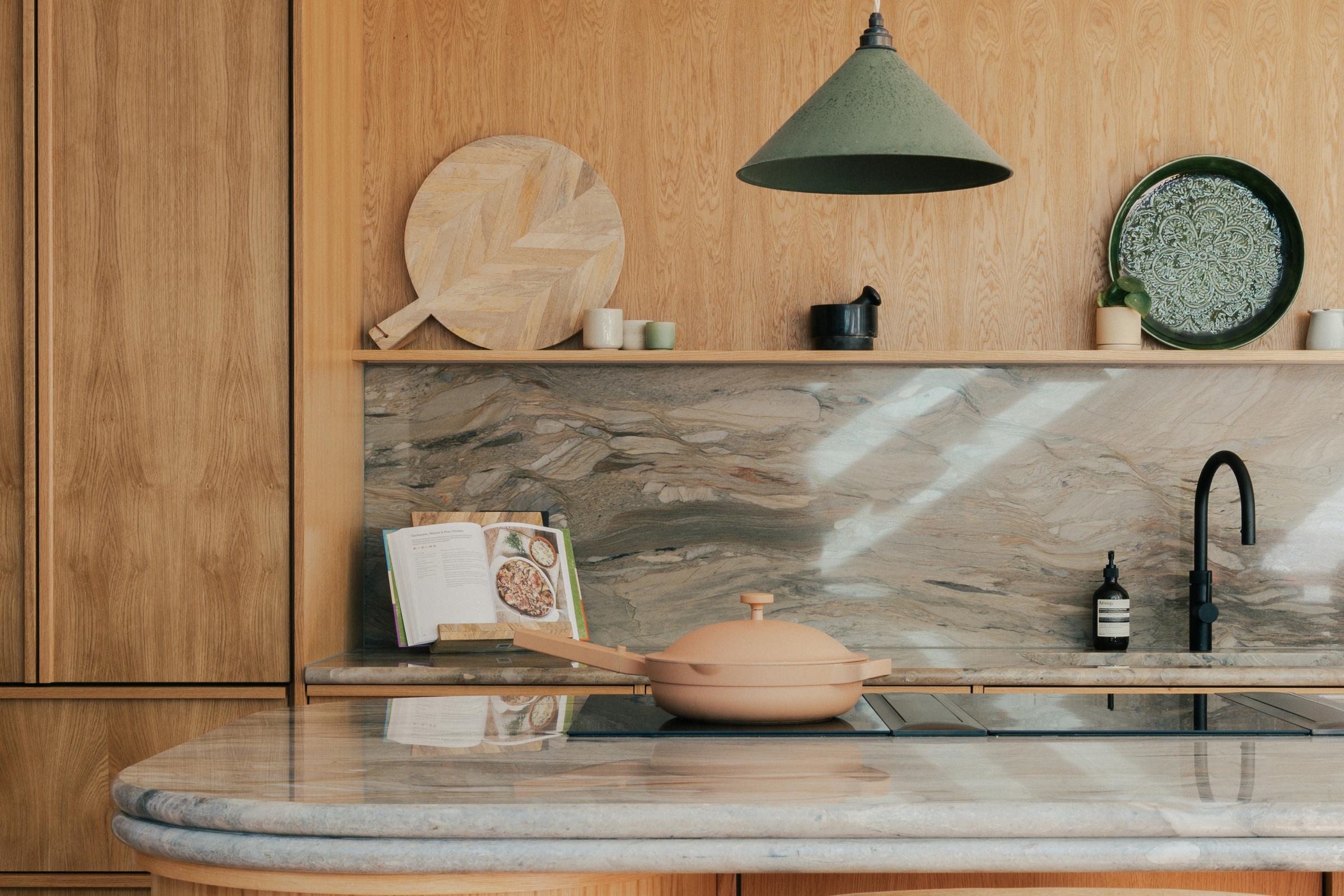 Symposion House wood kitchen renovation with island, marble worktops and open shelving in London