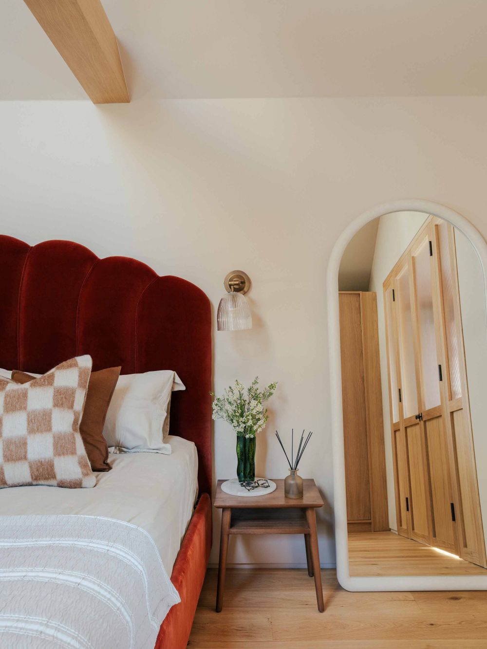 Statement bed in master bedroom with oak beams in London