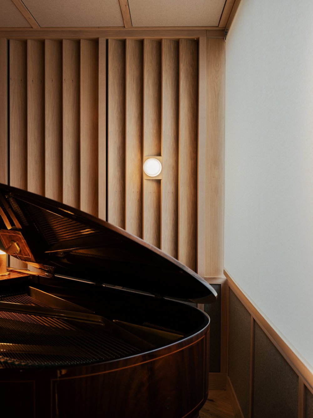 Composers Studio stylish piano room with wood panelling by architect and interior design studio Benjamin Wilkes