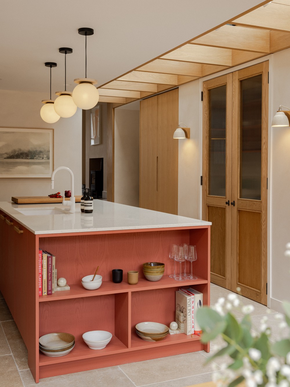 Coral kitchen island with a crisp white worktop at Strata House, showcasing bespoke residential interior design by Benjamin Wilkes in London.