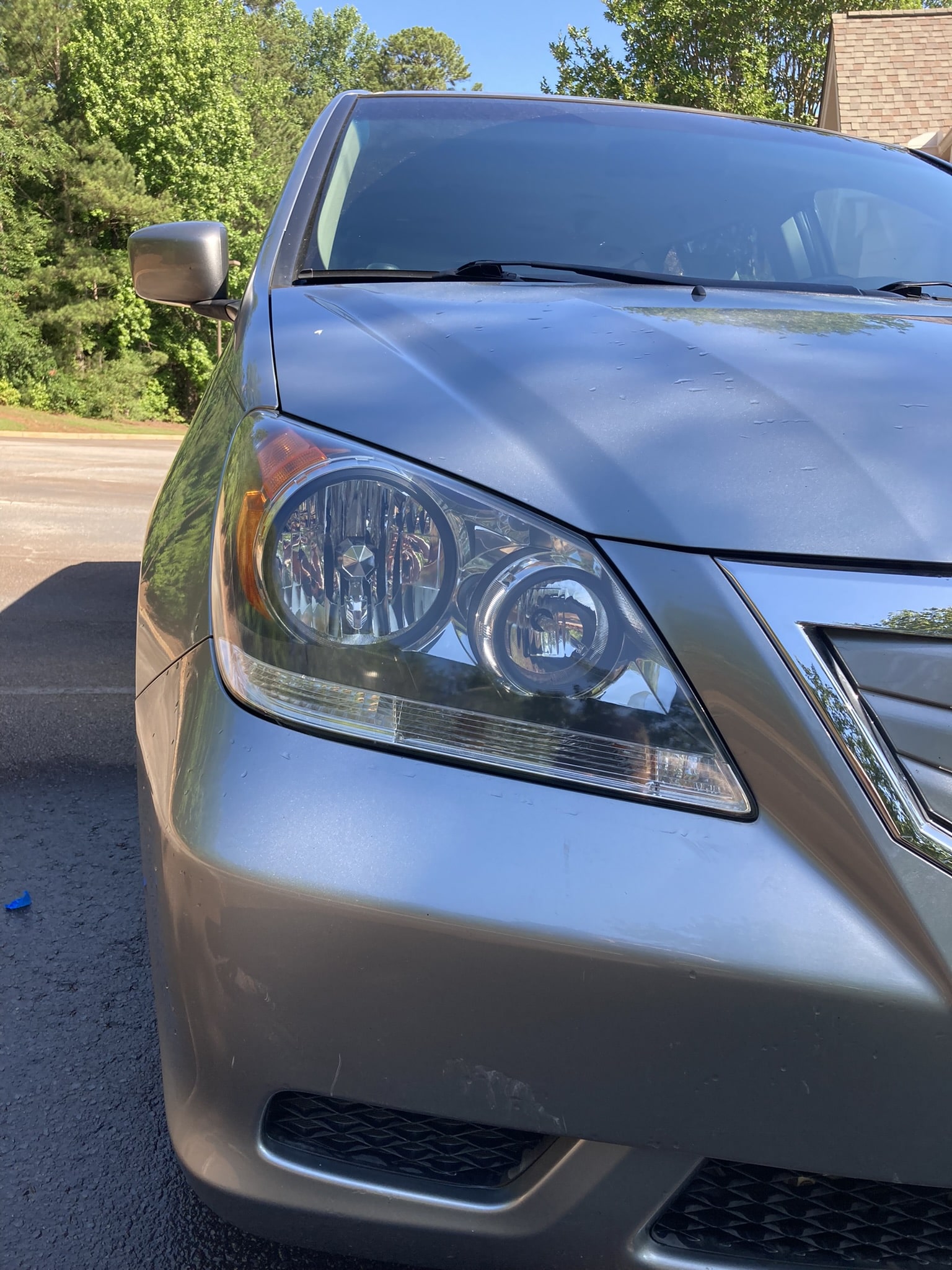 Picture of a headlight after a headlight restoration service by Ace Platinum Detailing.