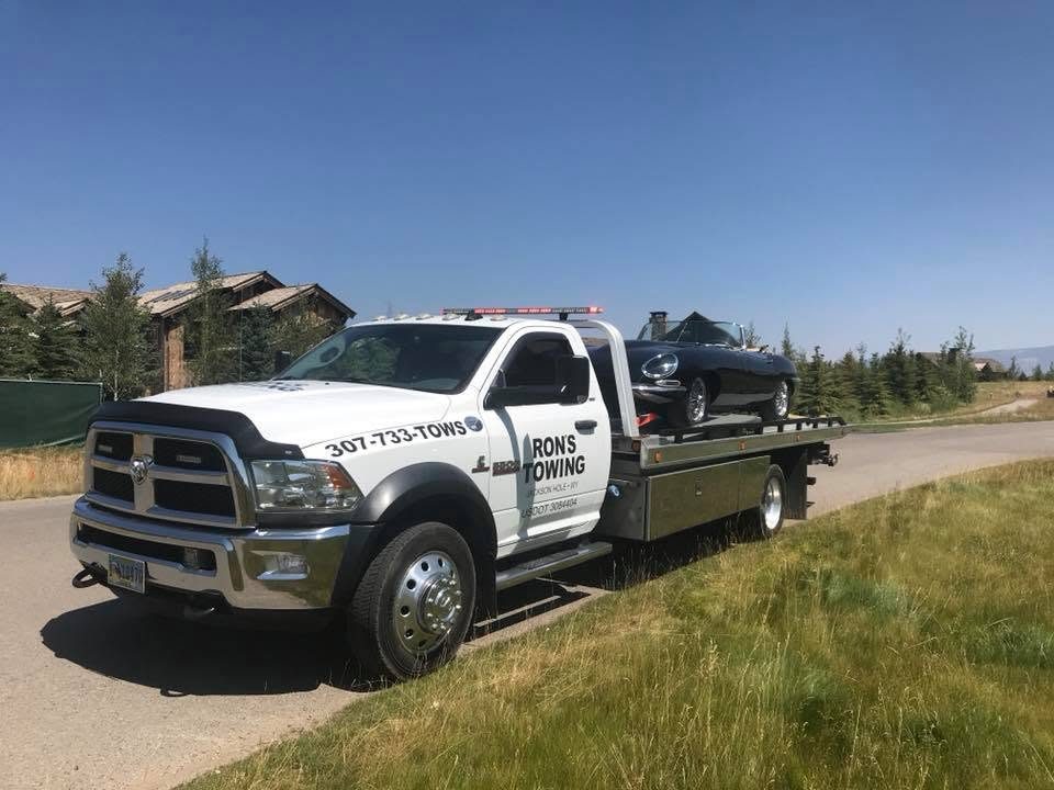 Ron's Towing flatbed towing a car in Jackson Hole