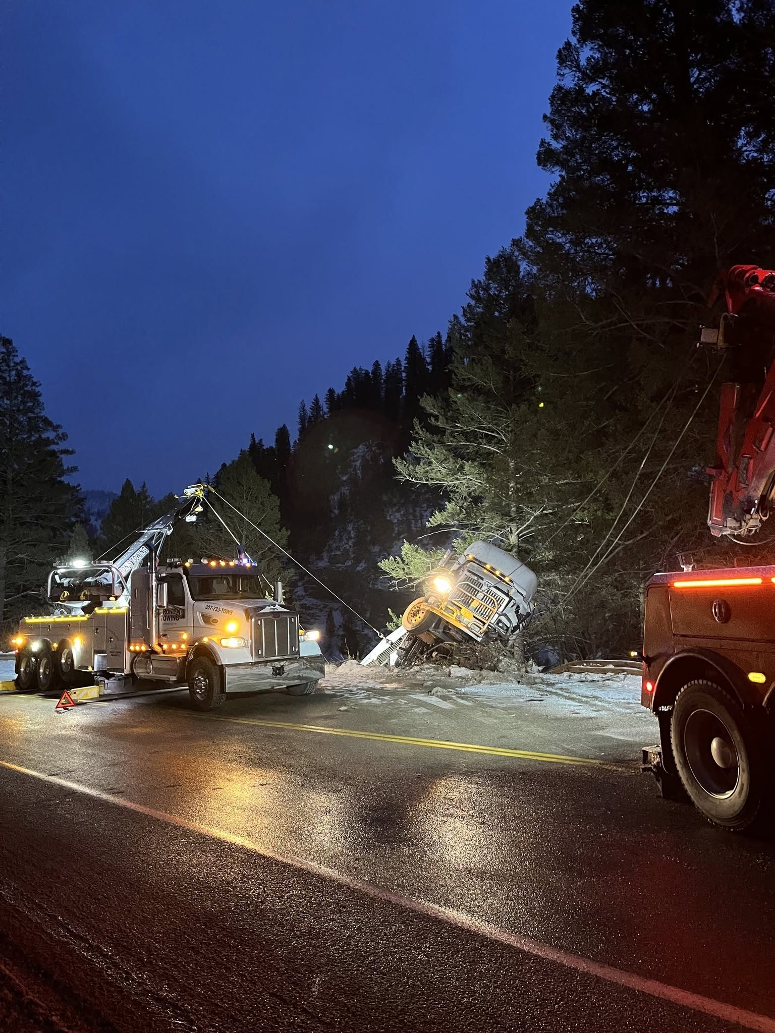 Heavy recovery boom lifting a trailer during a roadside recovery near Jackson