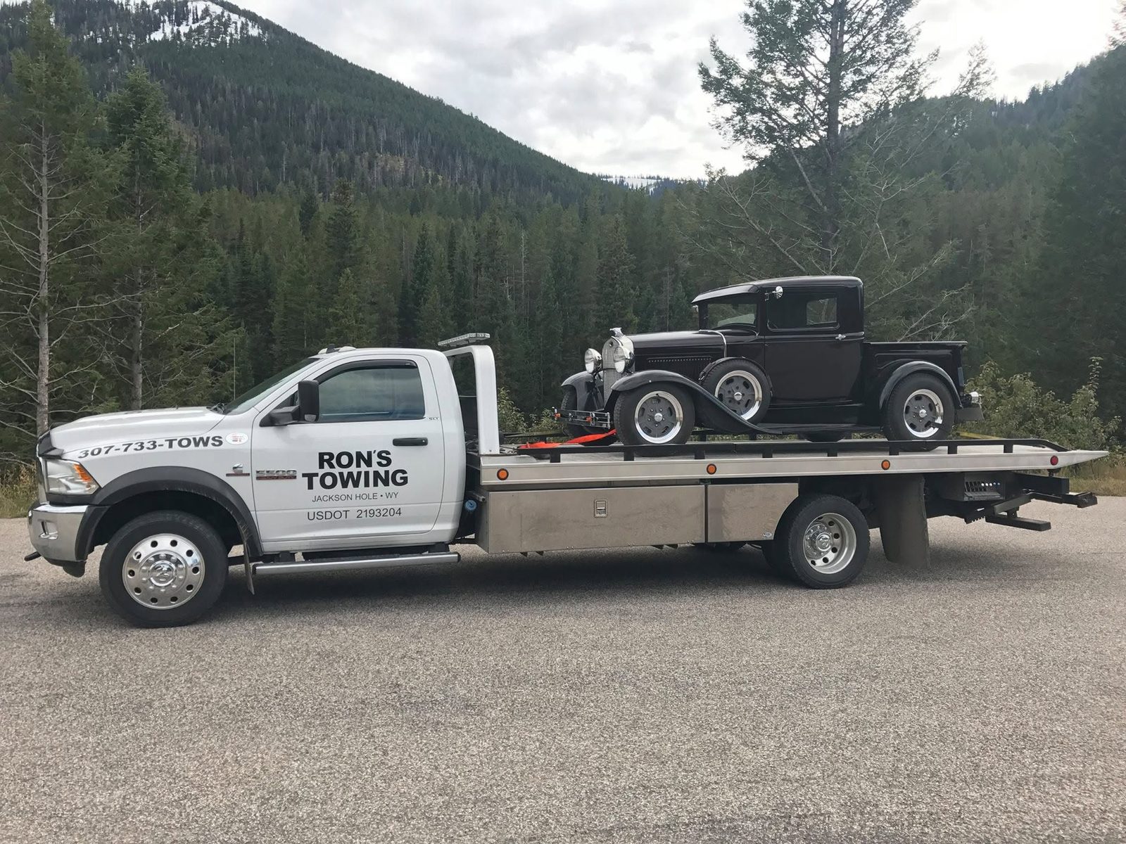 Classic vehicle transport on a Ron's Towing flatbed near Jackson Hole