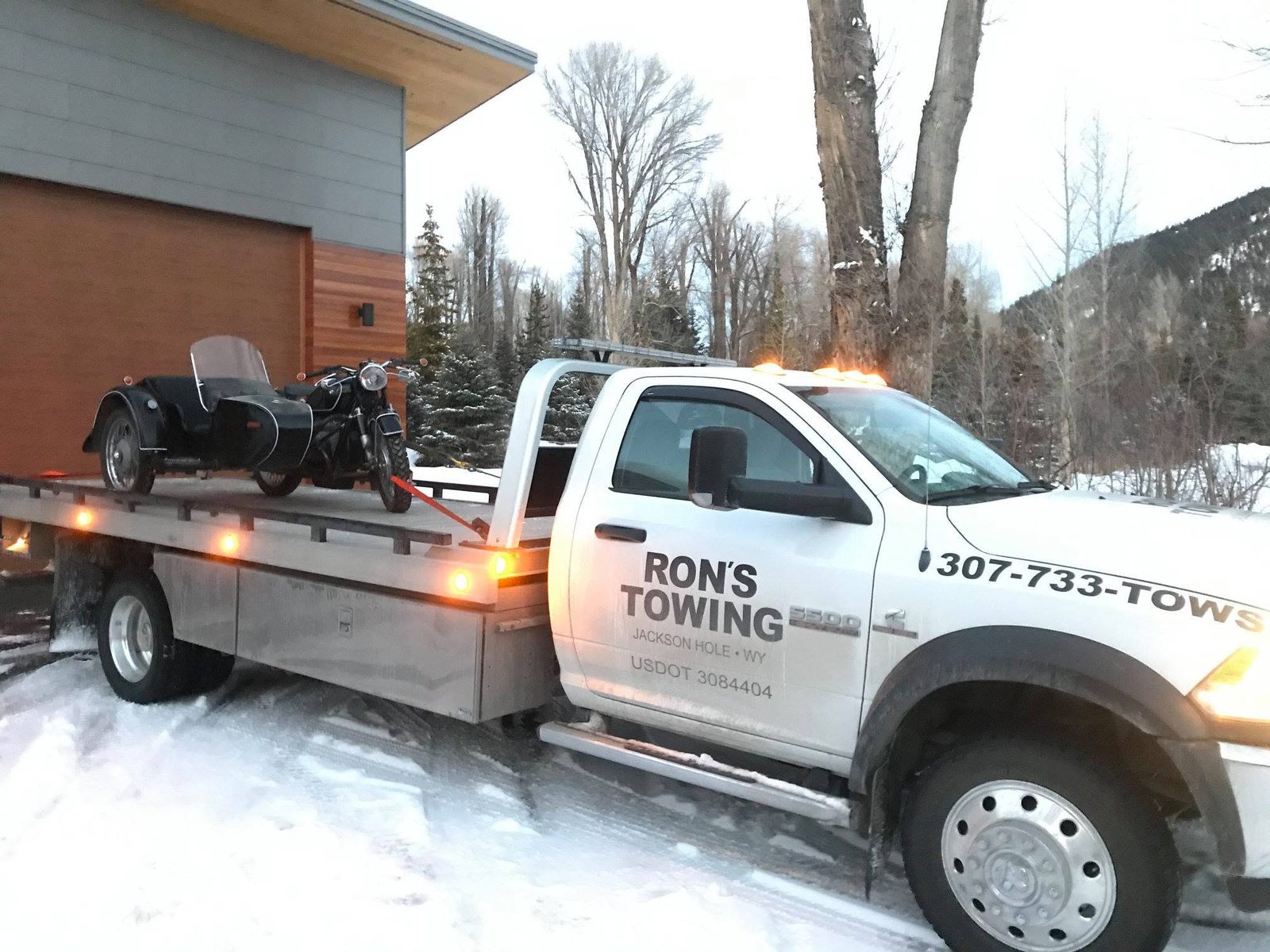 Motorcycle towing on a dedicated flatbed by Ron's Towing Jackson Hole