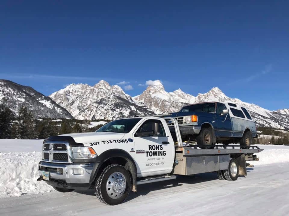 Winter towing of a 4x4 near Teton Village with the Tetons behind