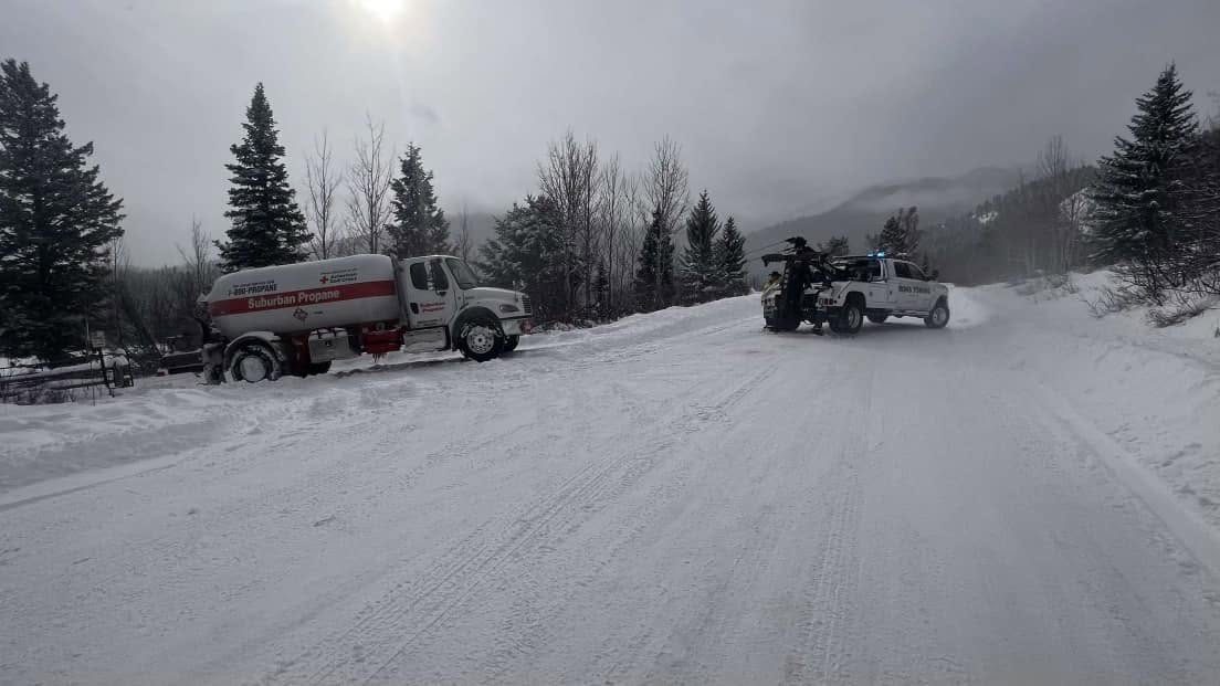 Winter vehicle recovery on a Teton Valley road near Victor, Idaho
