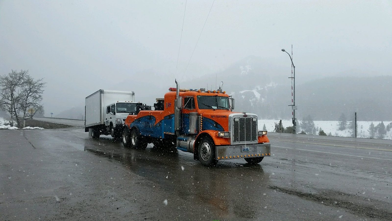 Winter box-truck tow on the Togwotee Pass corridor near Dubois