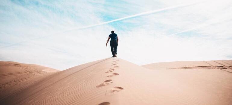 person walking on the sand