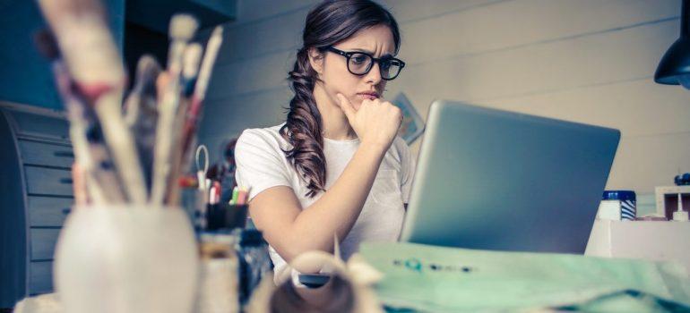 a woman doing research on her laptop before moving from Palmdale to Westwood alone