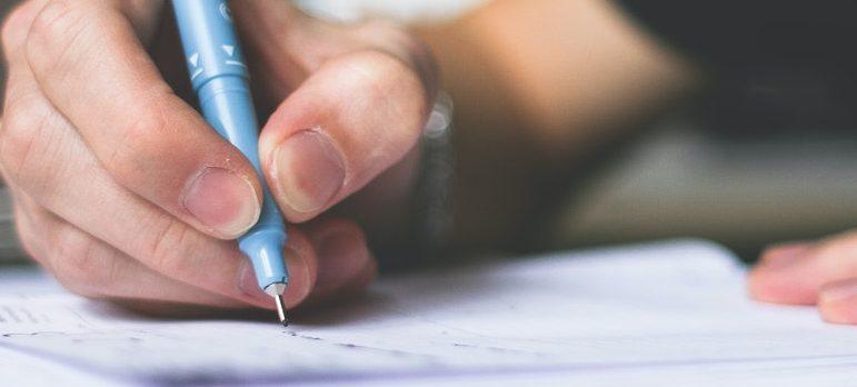 a person writing on a paper