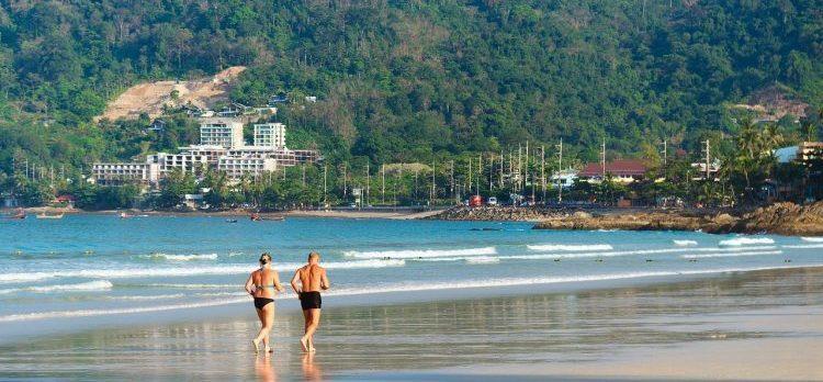 an old couple running on the beach