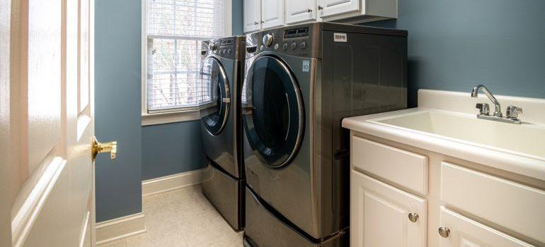 Front load washing machine beside window blinds