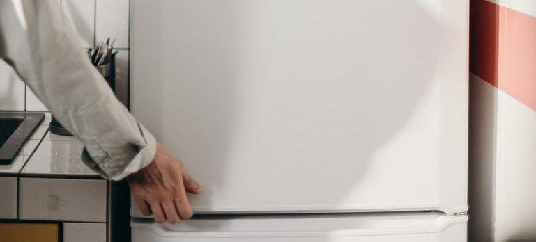 A person going trough walkthrough checklist before moving out and checking is fridge turned off