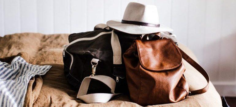 A bag and a backpack with the necessary things on the bed