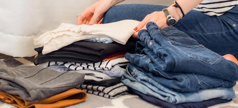 folding clothes to pack in your essentials bag for a long distance move from CA to NY