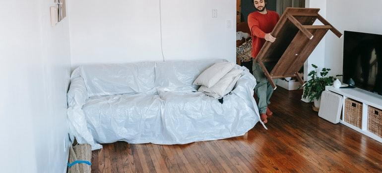 Man packing and moving bulky items